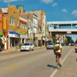 a man riding a bicycle on the street of Pilsen